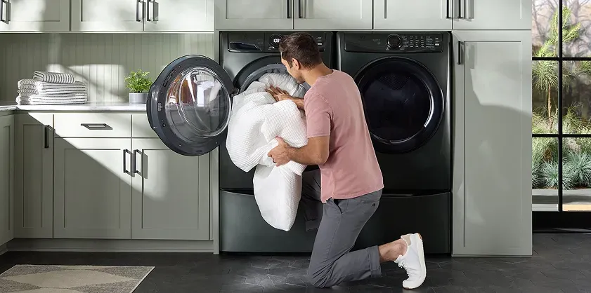 man-loading-electrolux-washing-machine